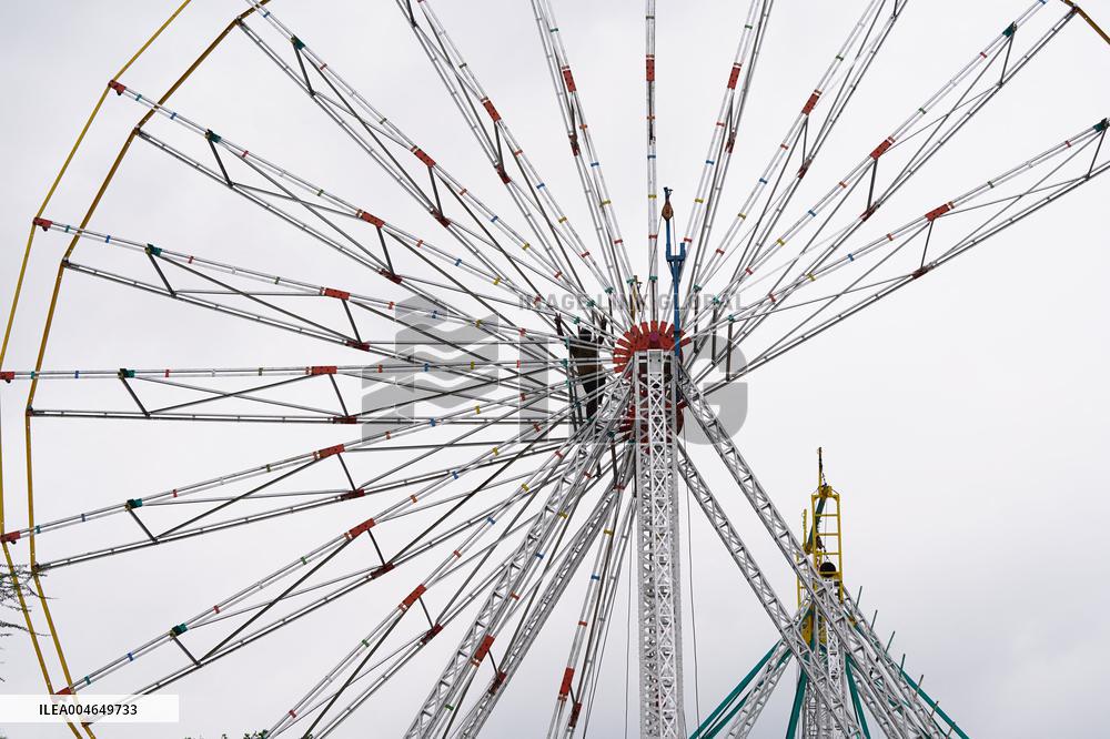 A Labourer Works on A Giant Ferris Wheel - India