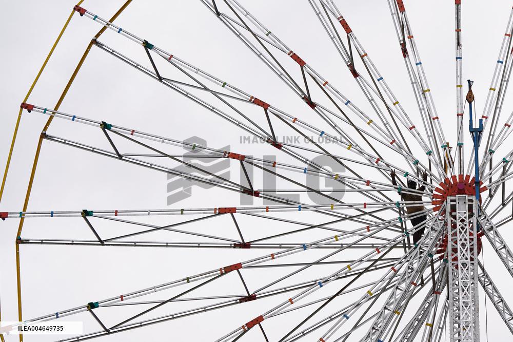A Labourer Works on A Giant Ferris Wheel - India
