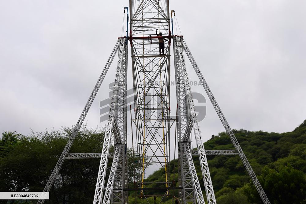 A Labourer Works on A Giant Ferris Wheel - India