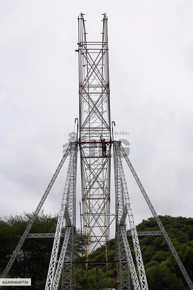 A Labourer Works on A Giant Ferris Wheel - India