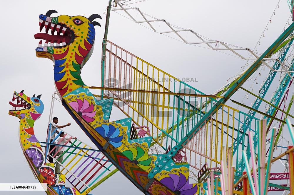A Labourer Works on A Giant Ferris Wheel - India