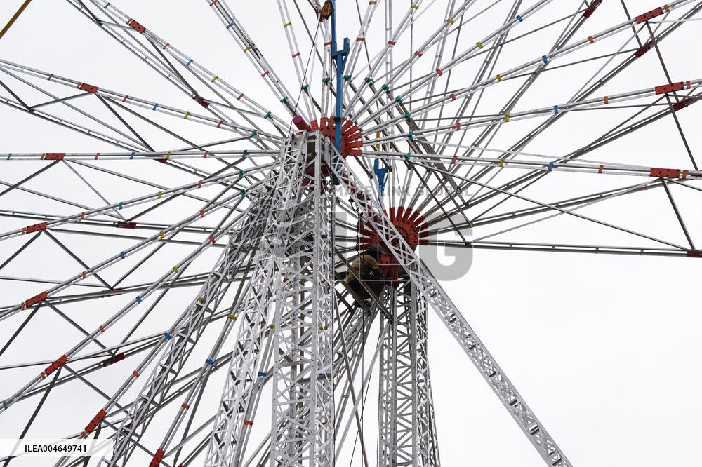 A Labourer Works on A Giant Ferris Wheel - India