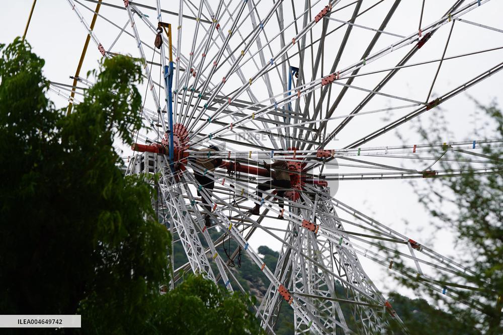 A Labourer Works on A Giant Ferris Wheel - India