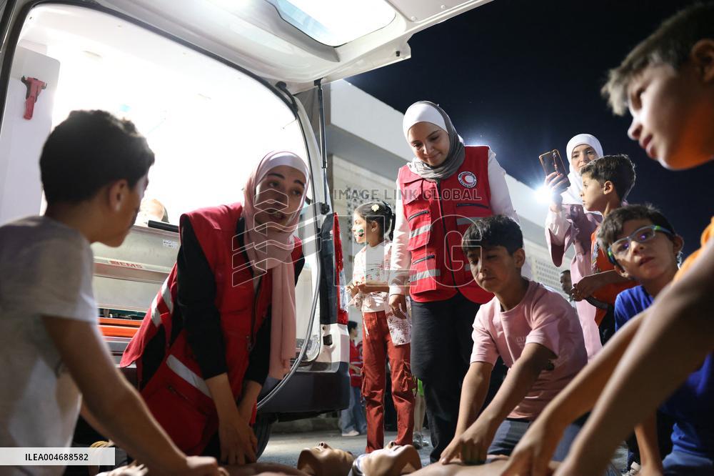 Syrian Red Crescent Volunteers Training Children In First Aid At Damascus International Fair