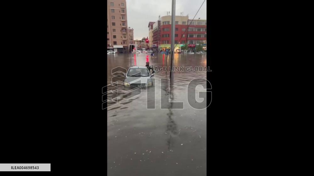 China: Cyclist Pedals Across Severely Flooded Road After Downpour in Inner Mongolia