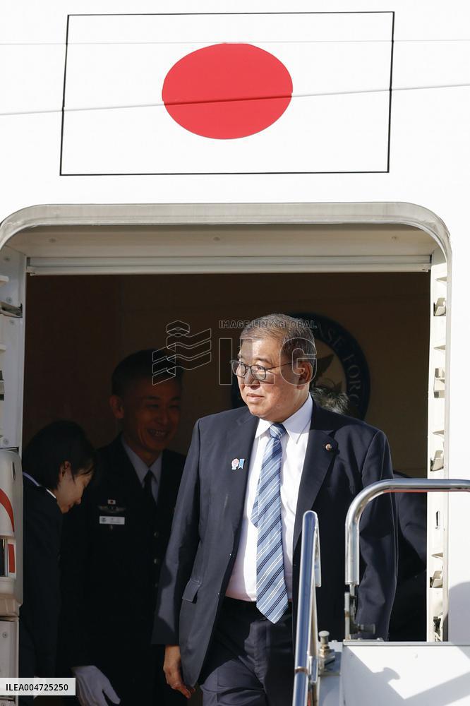 Japan PM returns home