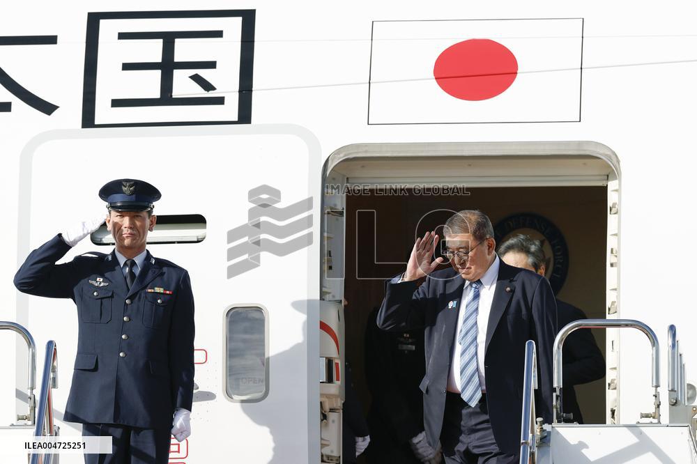Japan PM returns home