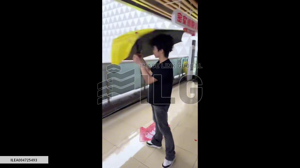 China: Man and Umbrella Toppled by Typhoon Gusts in Guangdong