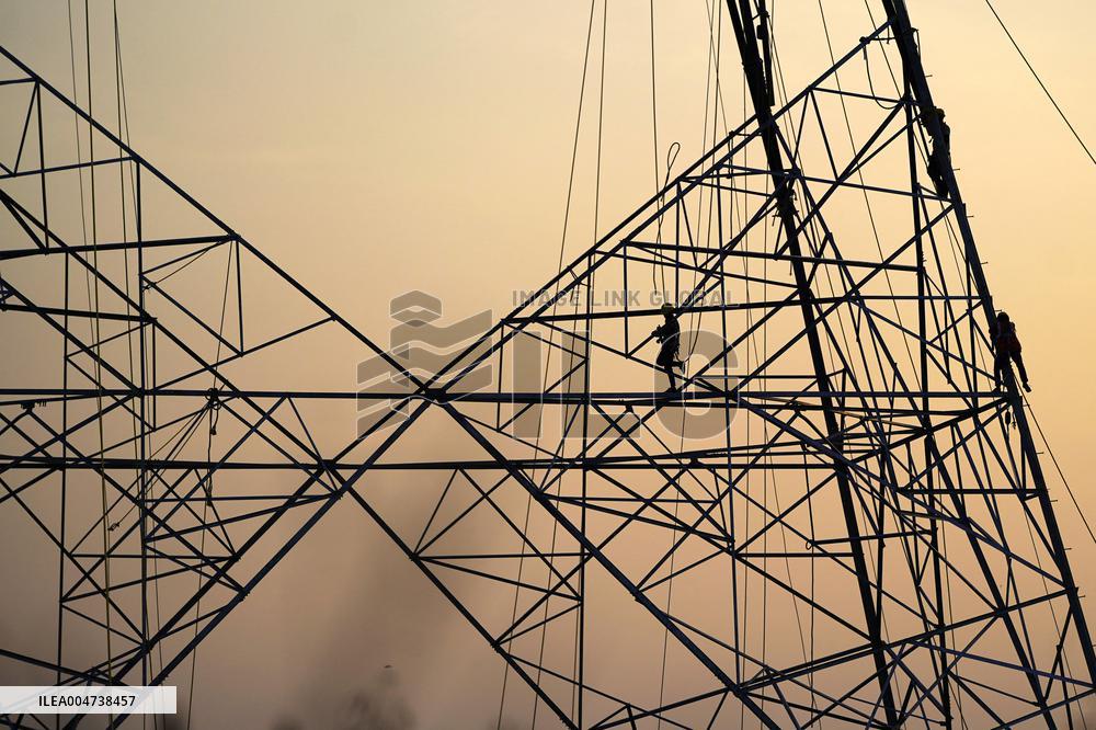Workers Are Installing a High-Voltage Electricity Pylon - India