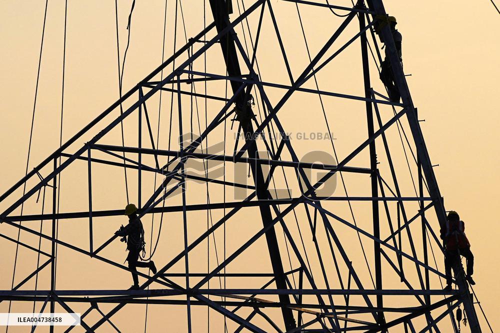 Workers Are Installing a High-Voltage Electricity Pylon - India