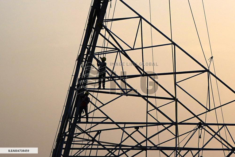 Workers Are Installing a High-Voltage Electricity Pylon - India
