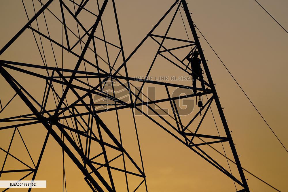 Workers Are Installing a High-Voltage Electricity Pylon - India