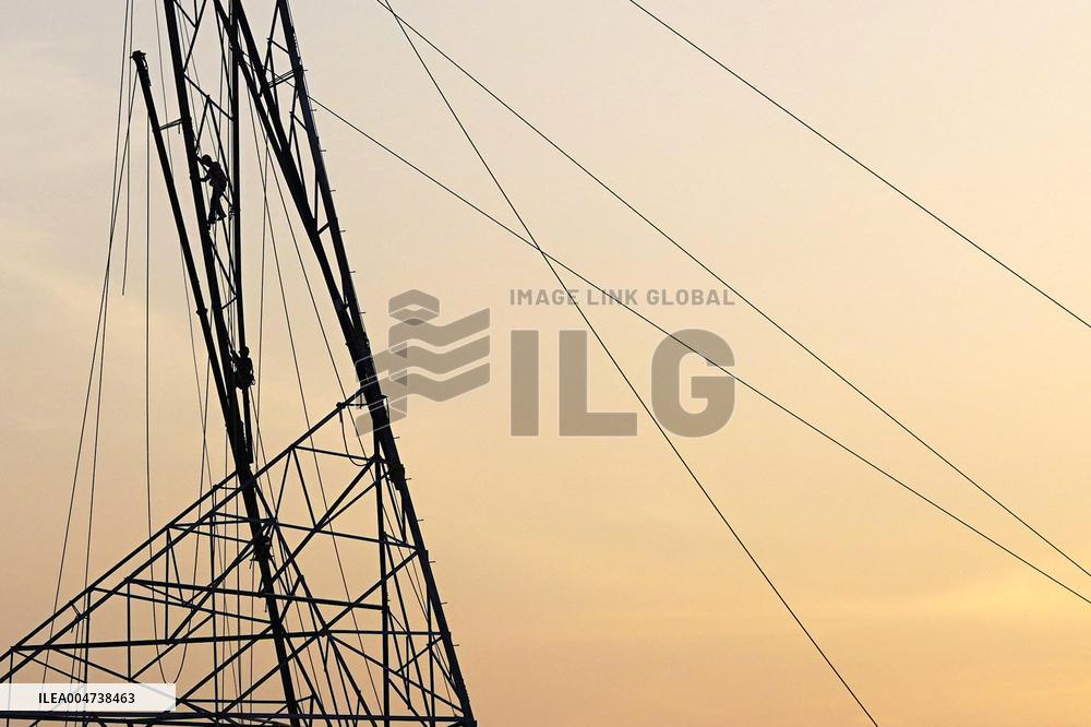 Workers Are Installing a High-Voltage Electricity Pylon - India