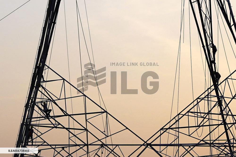 Workers Are Installing a High-Voltage Electricity Pylon - India