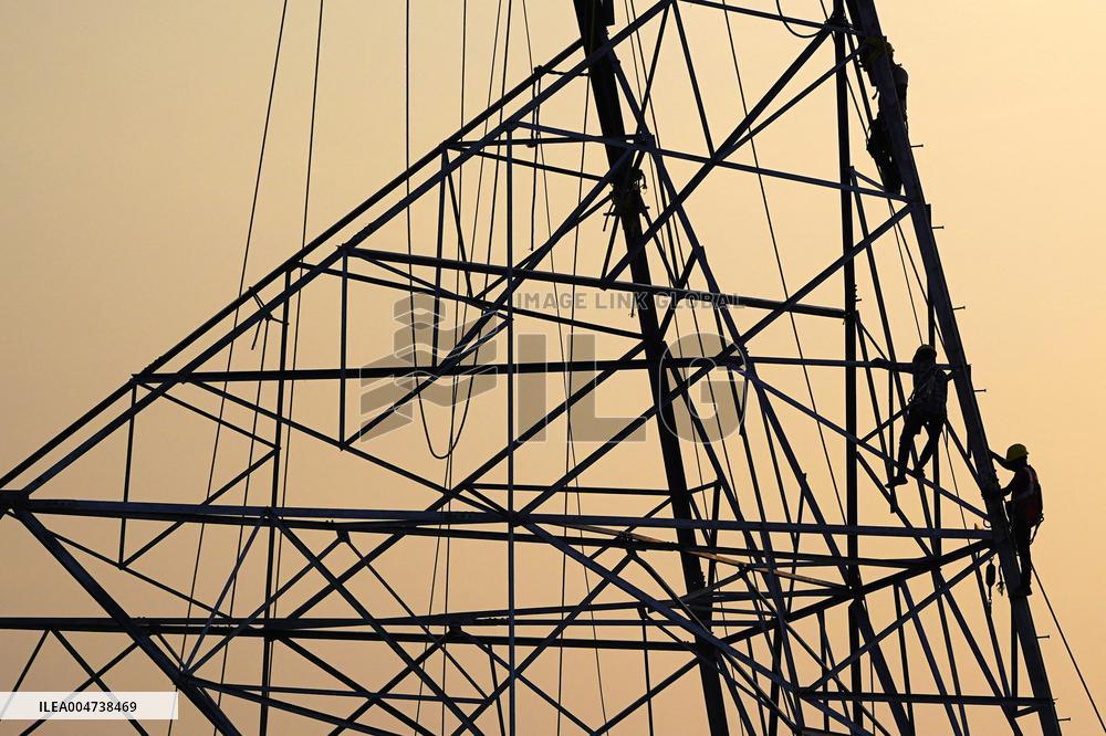 Workers Are Installing a High-Voltage Electricity Pylon - India