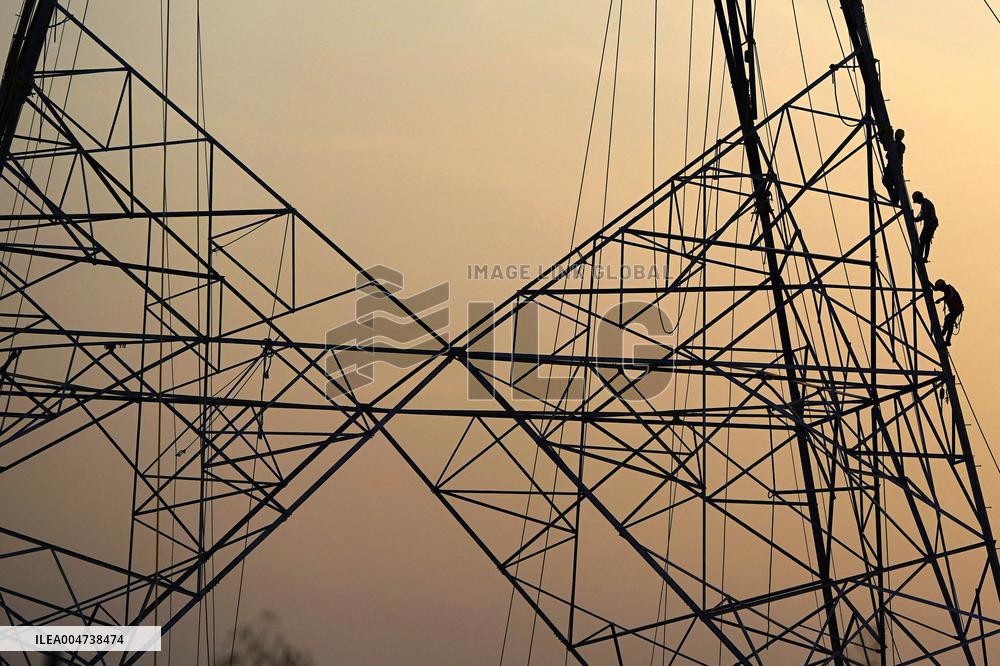 Workers Are Installing a High-Voltage Electricity Pylon - India