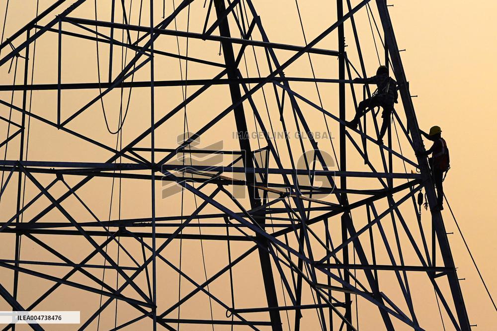 Workers Are Installing a High-Voltage Electricity Pylon - India