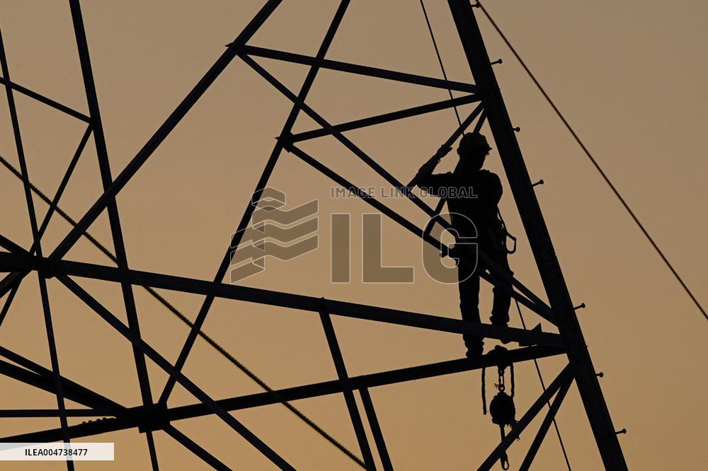 Workers Are Installing a High-Voltage Electricity Pylon - India