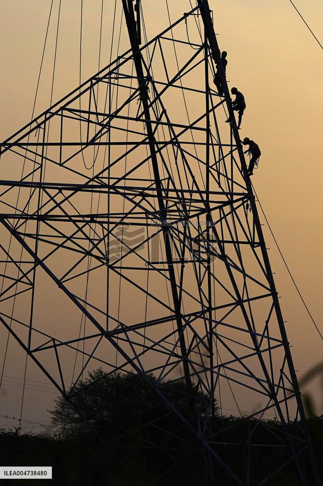 Workers Are Installing a High-Voltage Electricity Pylon - India