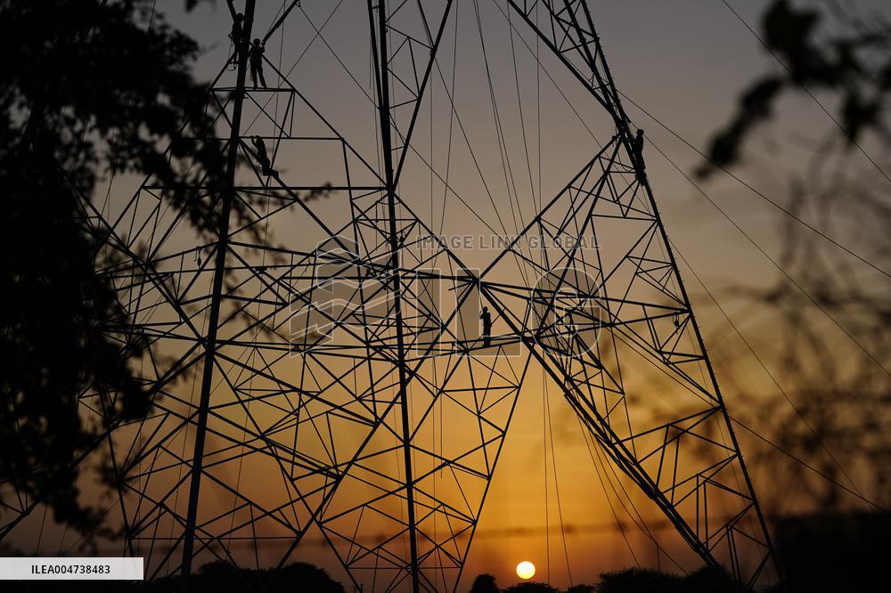 Workers Are Installing a High-Voltage Electricity Pylon - India