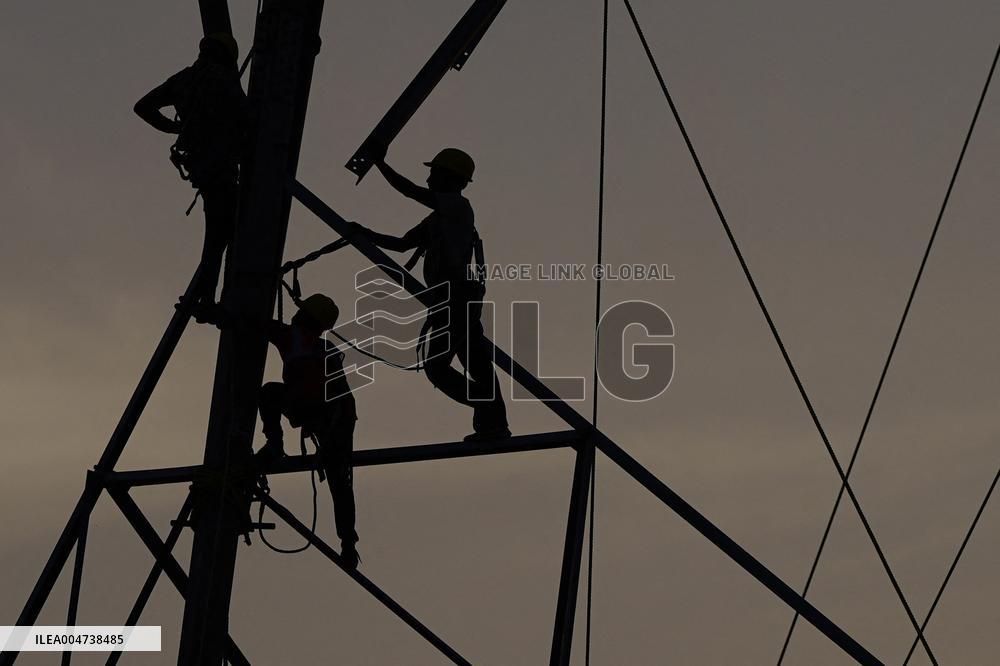 Workers Are Installing a High-Voltage Electricity Pylon - India