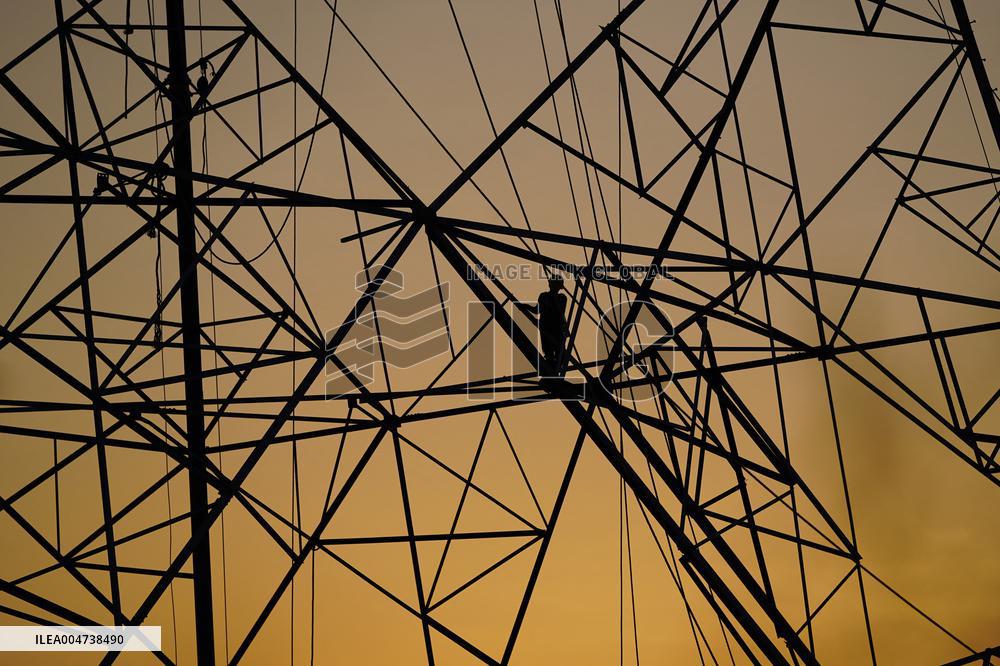 Workers Are Installing a High-Voltage Electricity Pylon - India