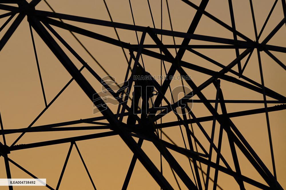 Workers Are Installing a High-Voltage Electricity Pylon - India