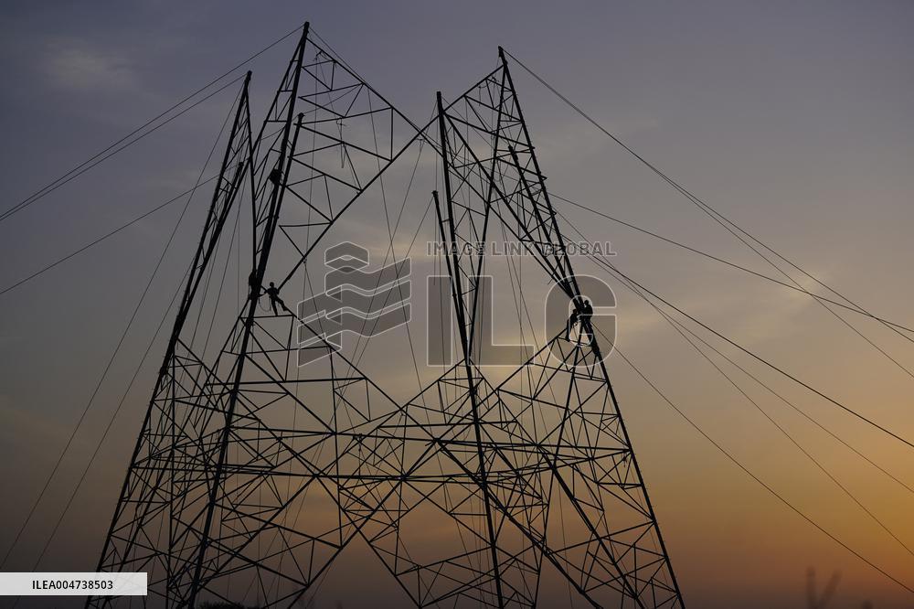Workers Are Installing a High-Voltage Electricity Pylon - India
