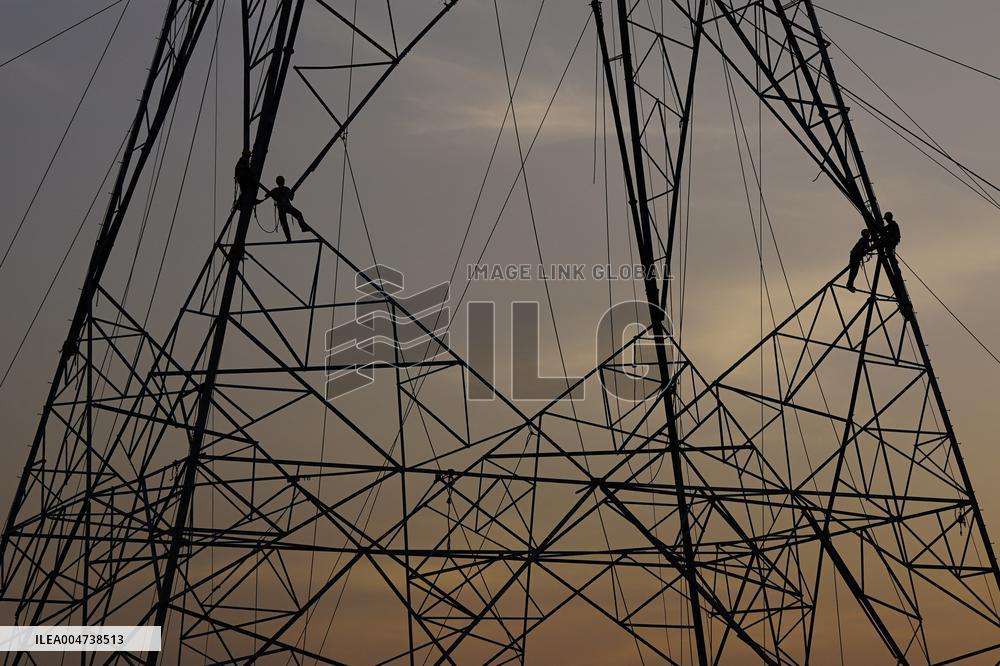 Workers Are Installing a High-Voltage Electricity Pylon - India