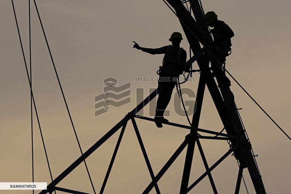 Workers Are Installing a High-Voltage Electricity Pylon - India