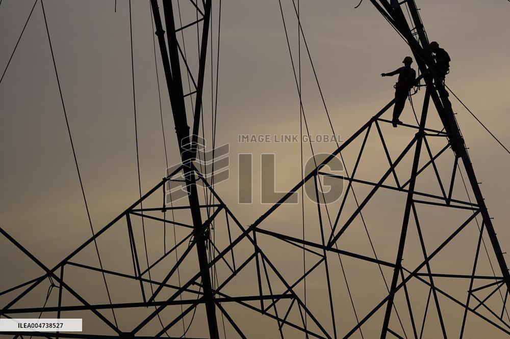 Workers Are Installing a High-Voltage Electricity Pylon - India