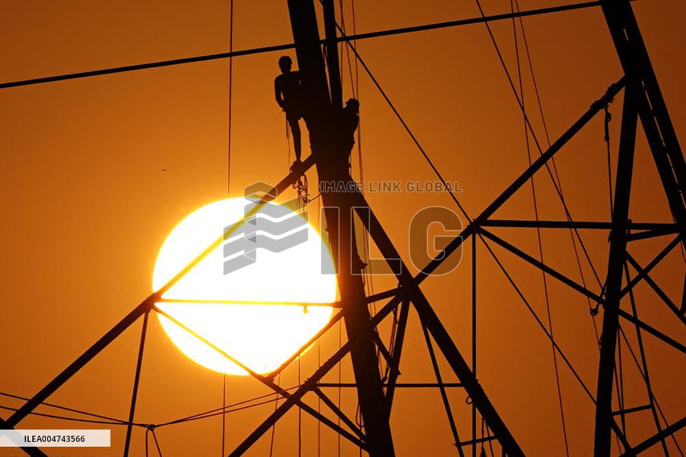 Workers Are Installing a High-Voltage Electricity Pylon - India