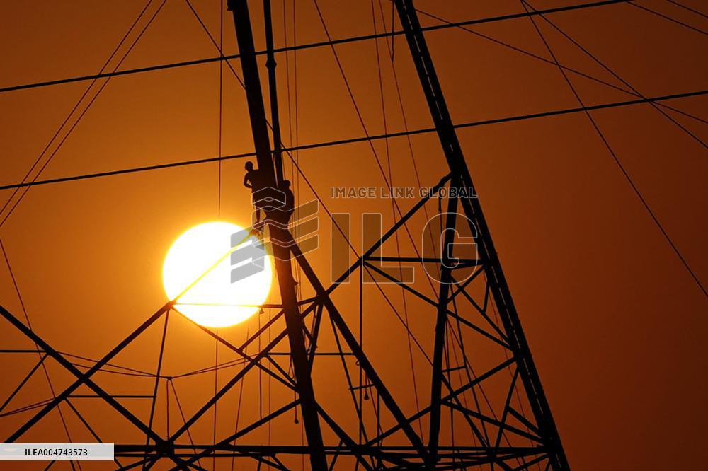 Workers Are Installing a High-Voltage Electricity Pylon - India