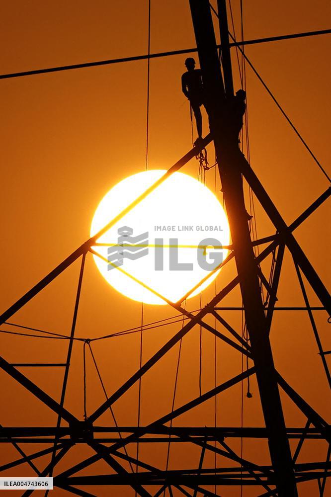 Workers Are Installing a High-Voltage Electricity Pylon - India