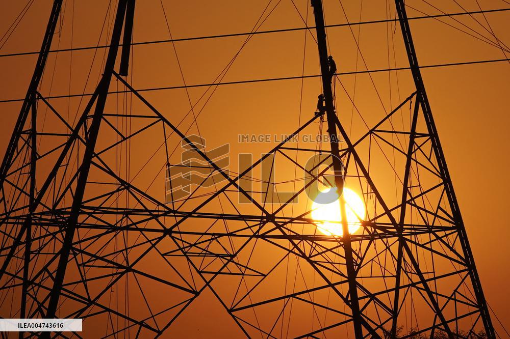 Workers Are Installing a High-Voltage Electricity Pylon - India