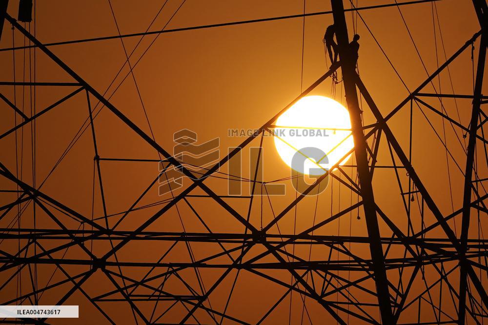 Workers Are Installing a High-Voltage Electricity Pylon - India