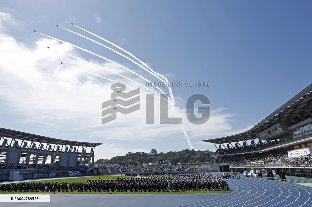 Blue Impulse aerobatic team flies over sports festival venue