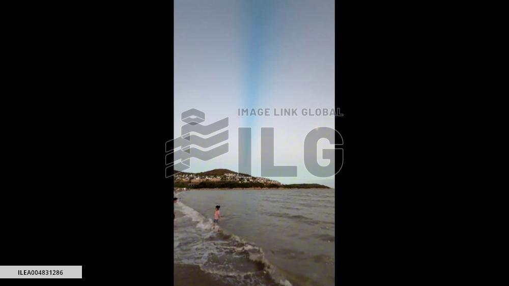 China: Mysterious Blue Beam Lights Up Night Sky Over Ningbo Beach