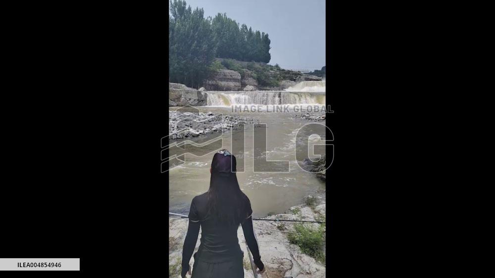 China: Man Uses Long Spear to Catch Fish in Fast-Flowing River in Hebei