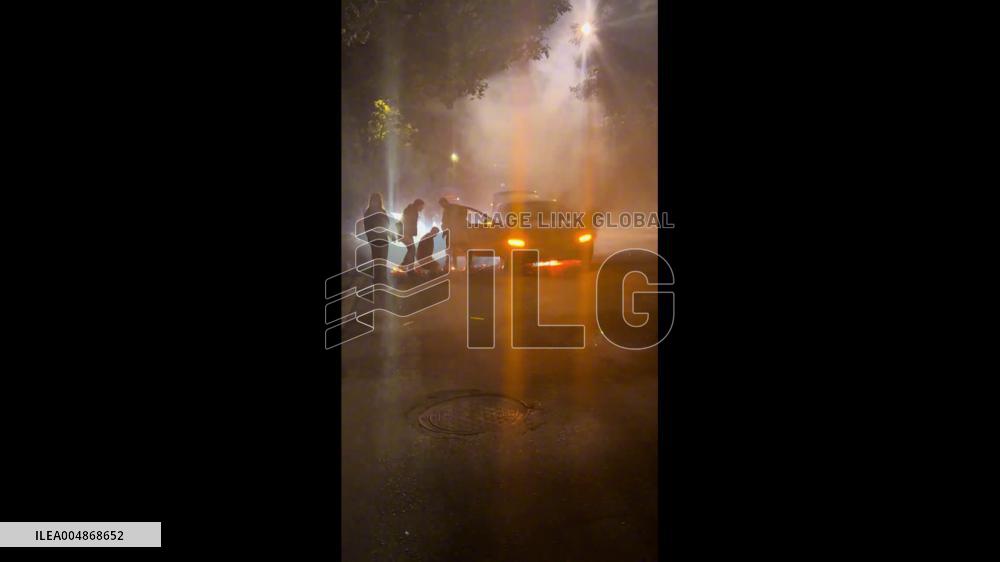 China: Car Catches Fire on Chengdu Street; Bystanders Rush to Help