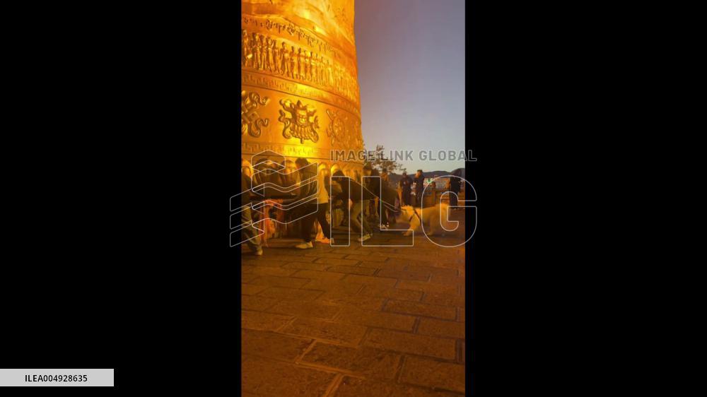 China: Loyal Dog Tries to Pull Owner Away From Giant Prayer Wheel