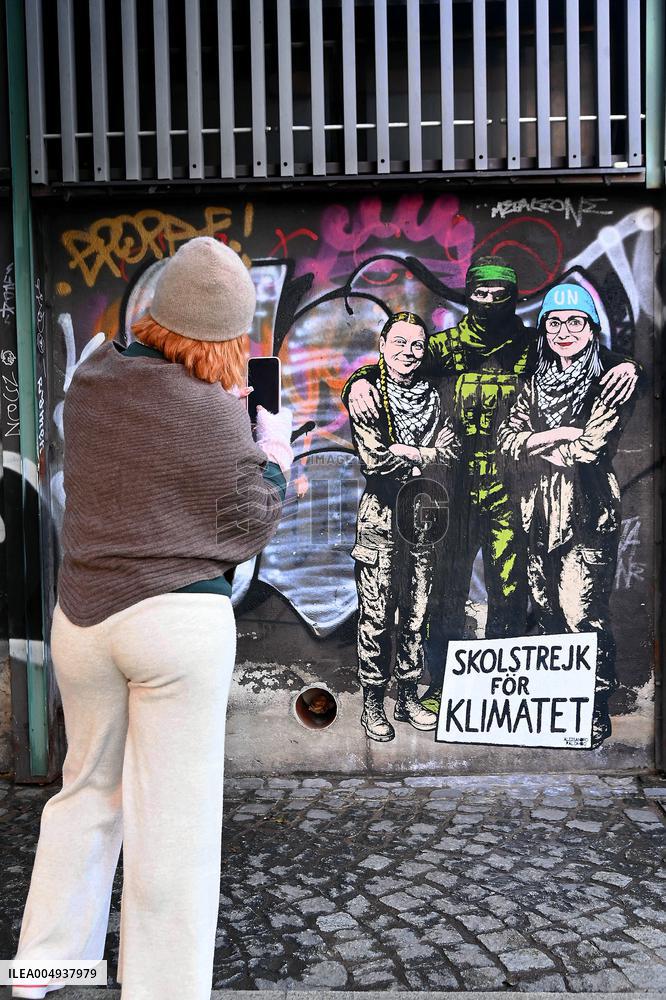 Provocative Wall Art Depicting Thunberg and Albanese with a Hamas Militant - Milan