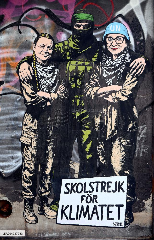 Provocative Wall Art Depicting Thunberg and Albanese with a Hamas Militant - Milan