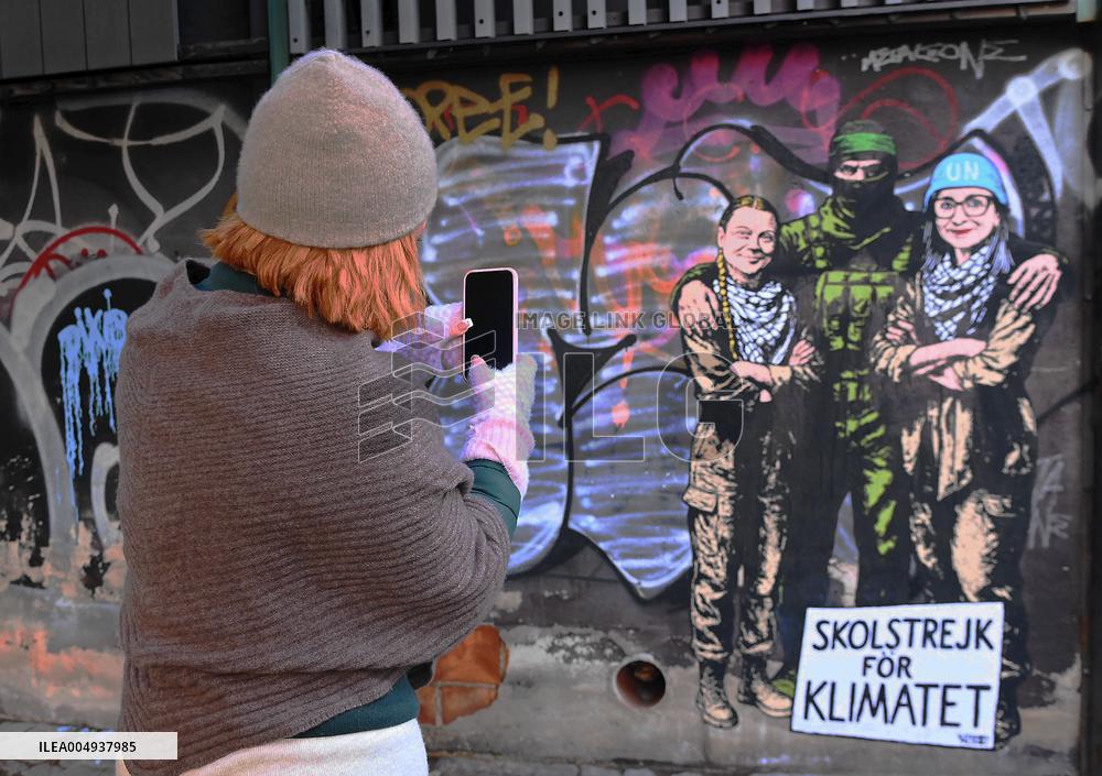 Provocative Wall Art Depicting Thunberg and Albanese with a Hamas Militant - Milan