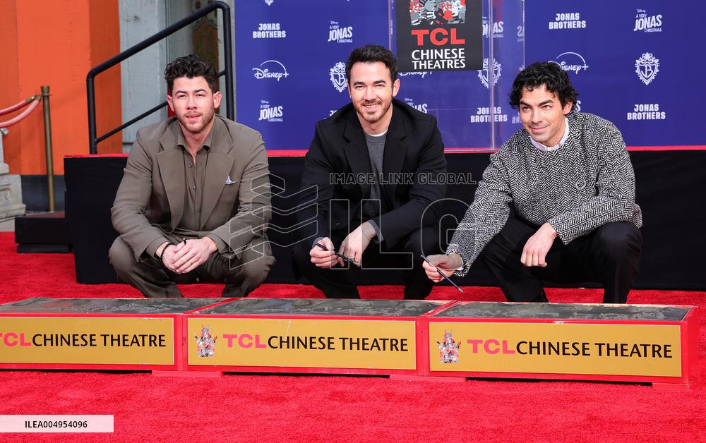 Jonas Brothers Hand And Footprint In Cement Ceremony - LA