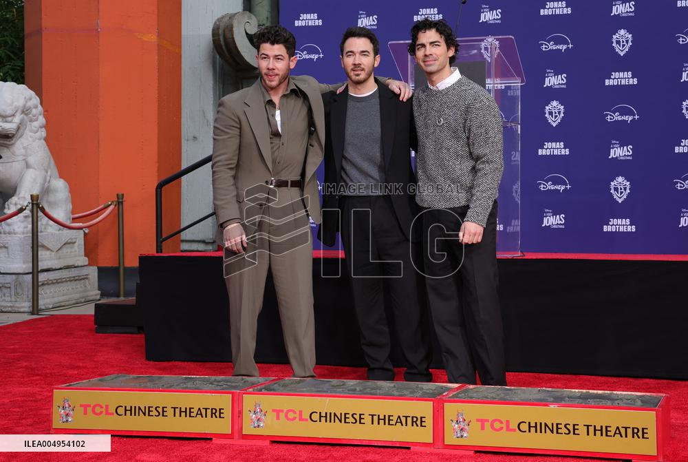 Jonas Brothers Hand And Footprint In Cement Ceremony - LA