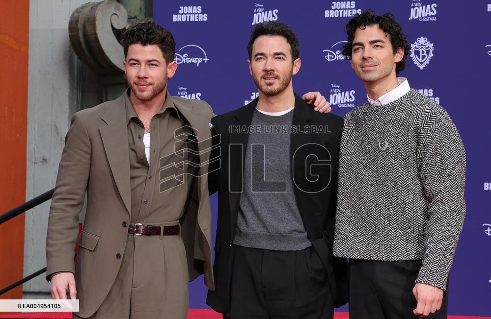 Jonas Brothers Hand And Footprint In Cement Ceremony - LA