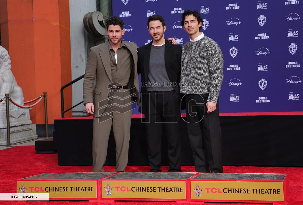Jonas Brothers Hand And Footprint In Cement Ceremony - LA