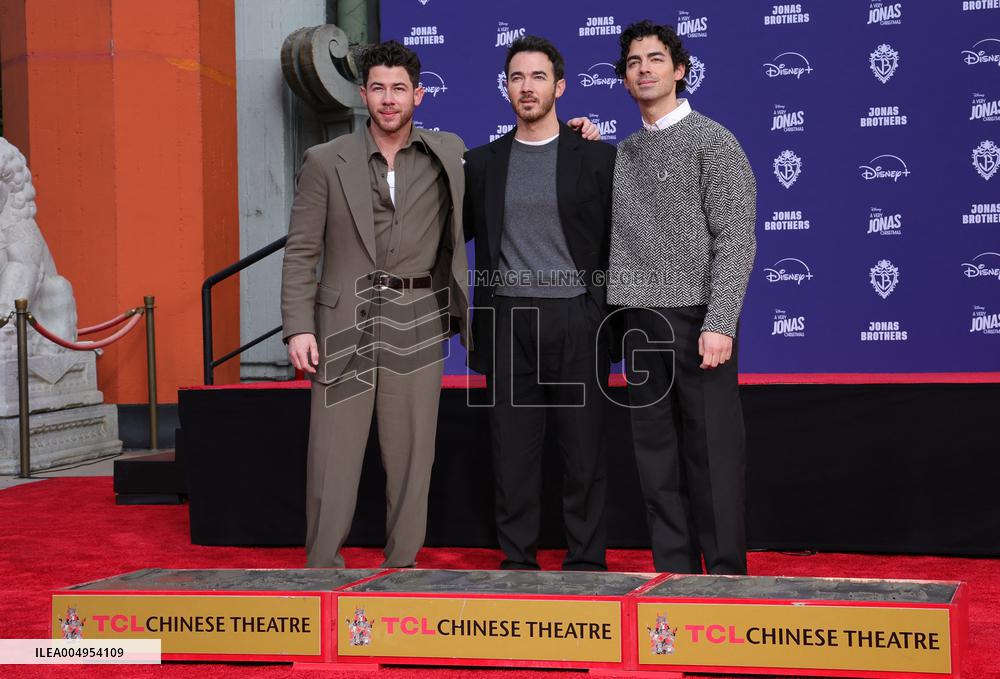 Jonas Brothers Hand And Footprint In Cement Ceremony - LA