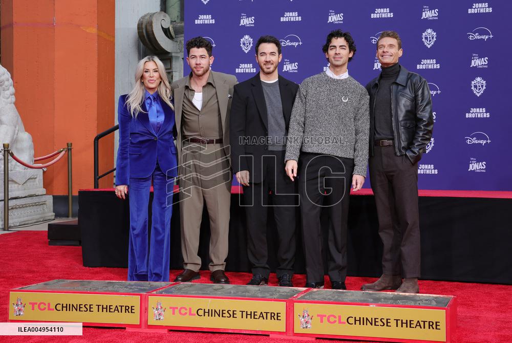 Jonas Brothers Hand And Footprint In Cement Ceremony - LA